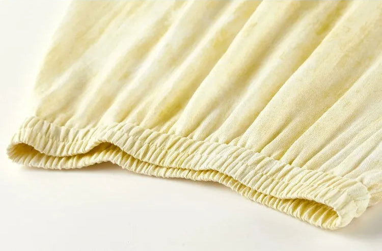 Detailed view of the elasticated waistband and the start of the flared skirt design — From Borcelleclothes.