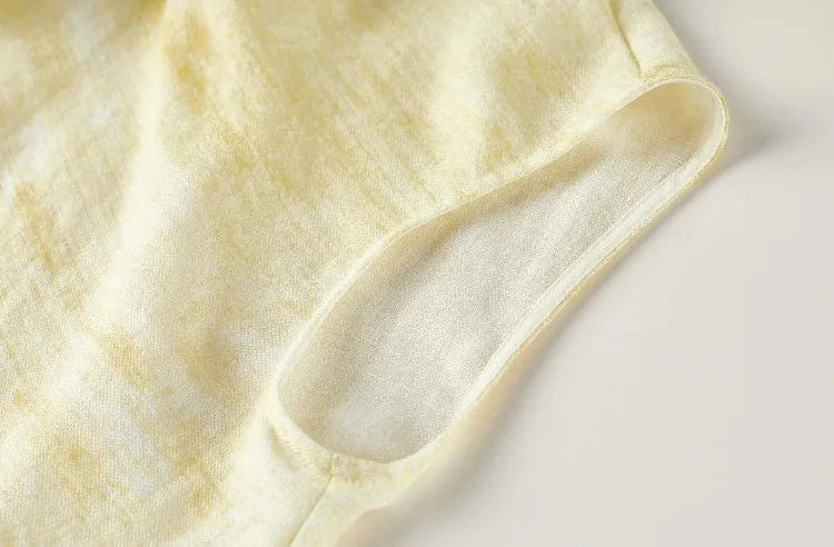 Close-up of the clean-finished armhole and dropped shoulder design of the asymmetrical top — From Borcelleclothes.