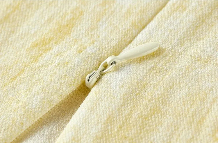 Close-up of the central back invisible zipper, partially unzipped from the bottom — From Borcelleclothes.
