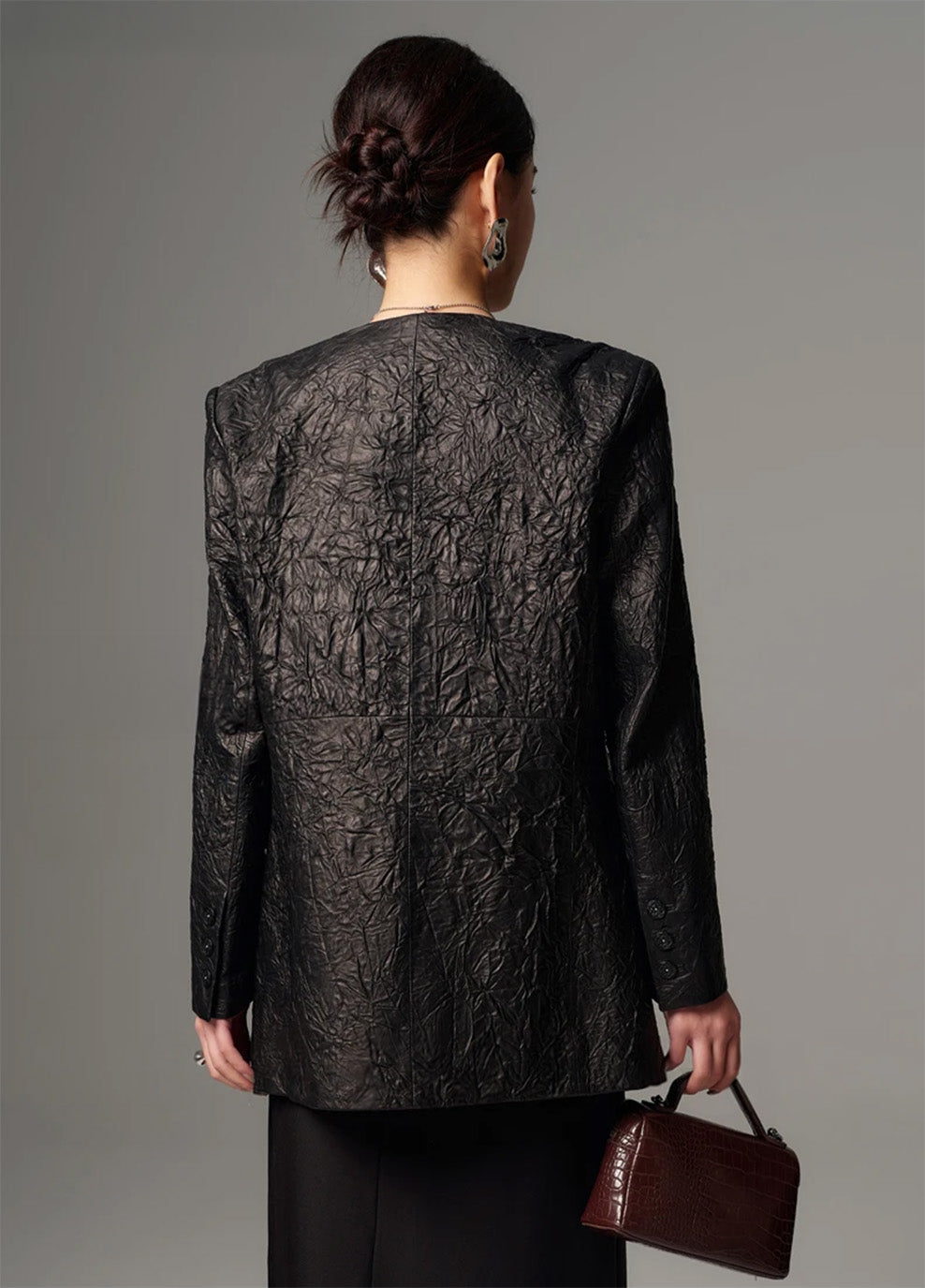 Back view of a women's long crinkled full-grain sheepskin jacket showing clean drape and straight cut — From Borcelleclothes.