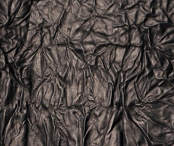 Close-up of crinkled full-grain sheepskin leather texture in deep Crinkled Nocturne black — From Borcelleclothes.