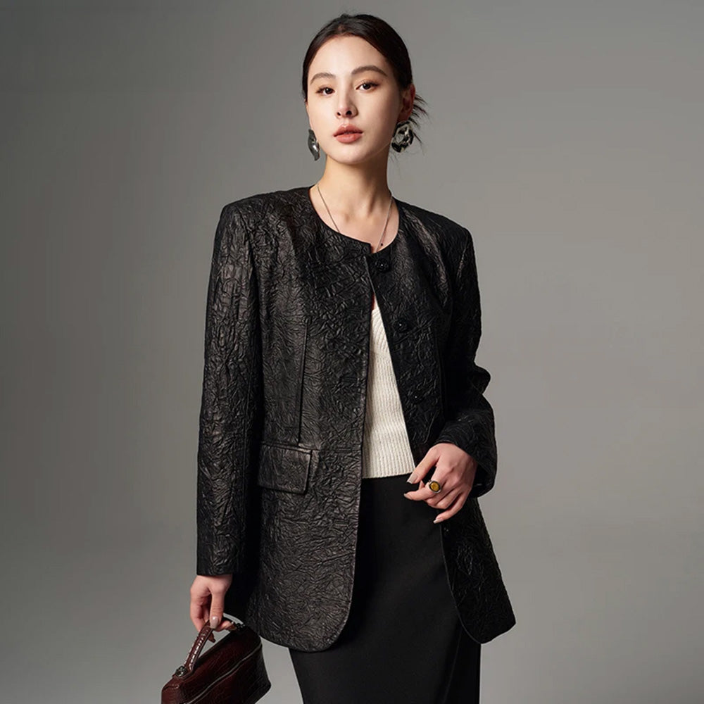 Women's Full-grain sheepskin leather jacket in Crinkled Nocturne. Semi-fitted collarless design featuring exposed front darts and delicate pearl-centered woven buttons. — From Borcelleclothes.