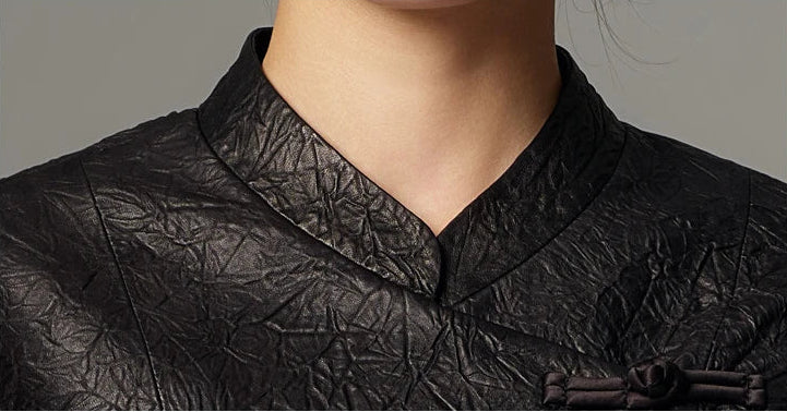 Close-up detail of the structured mandarin collar and neckline seam on the crinkled sheepskin jacket in Frost-Glazed Lava — From Borcelleclothes.
