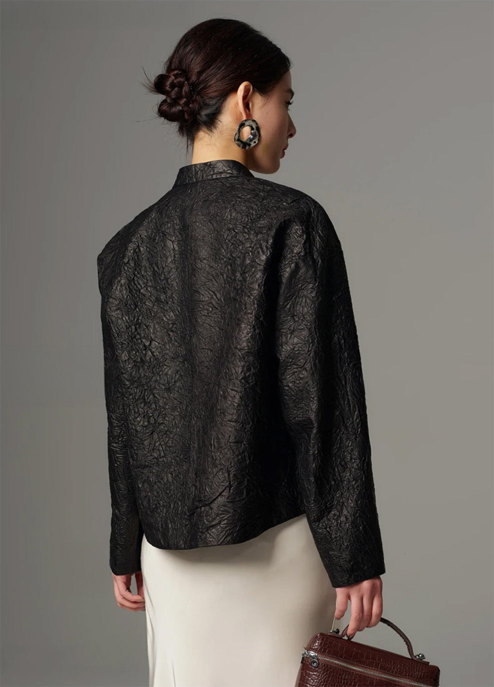 Back view of the cropped crinkled sheepskin jacket in Frost-Glazed Lava, showcasing the dropped shoulders and clean sculptural drape — From Borcelleclothes.