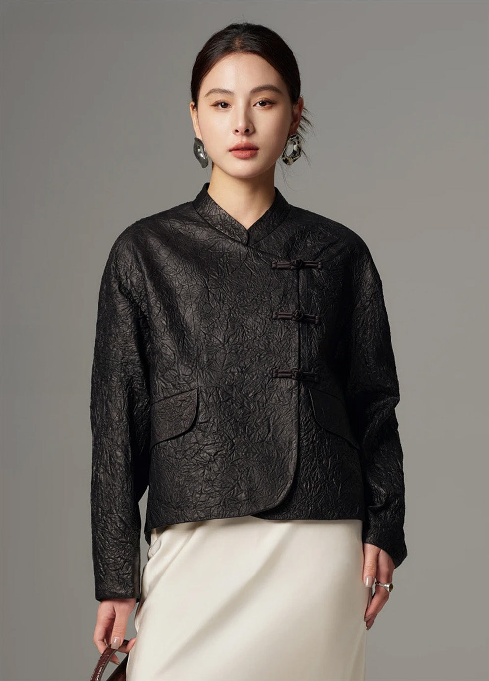 Front portrait of the model looking directly into the camera, styled in the cropped crinkled sheepskin pankou jacket in Frost-Glazed Lava — From Borcelleclothes.