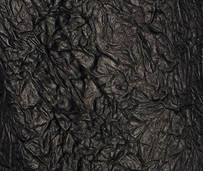 Close-up macro view of the full-grain crinkled sheepskin texture in Frost-Glazed Lava, highlighting deep natural creases and a low-sheen waxy finish — From Borcelleclothes.