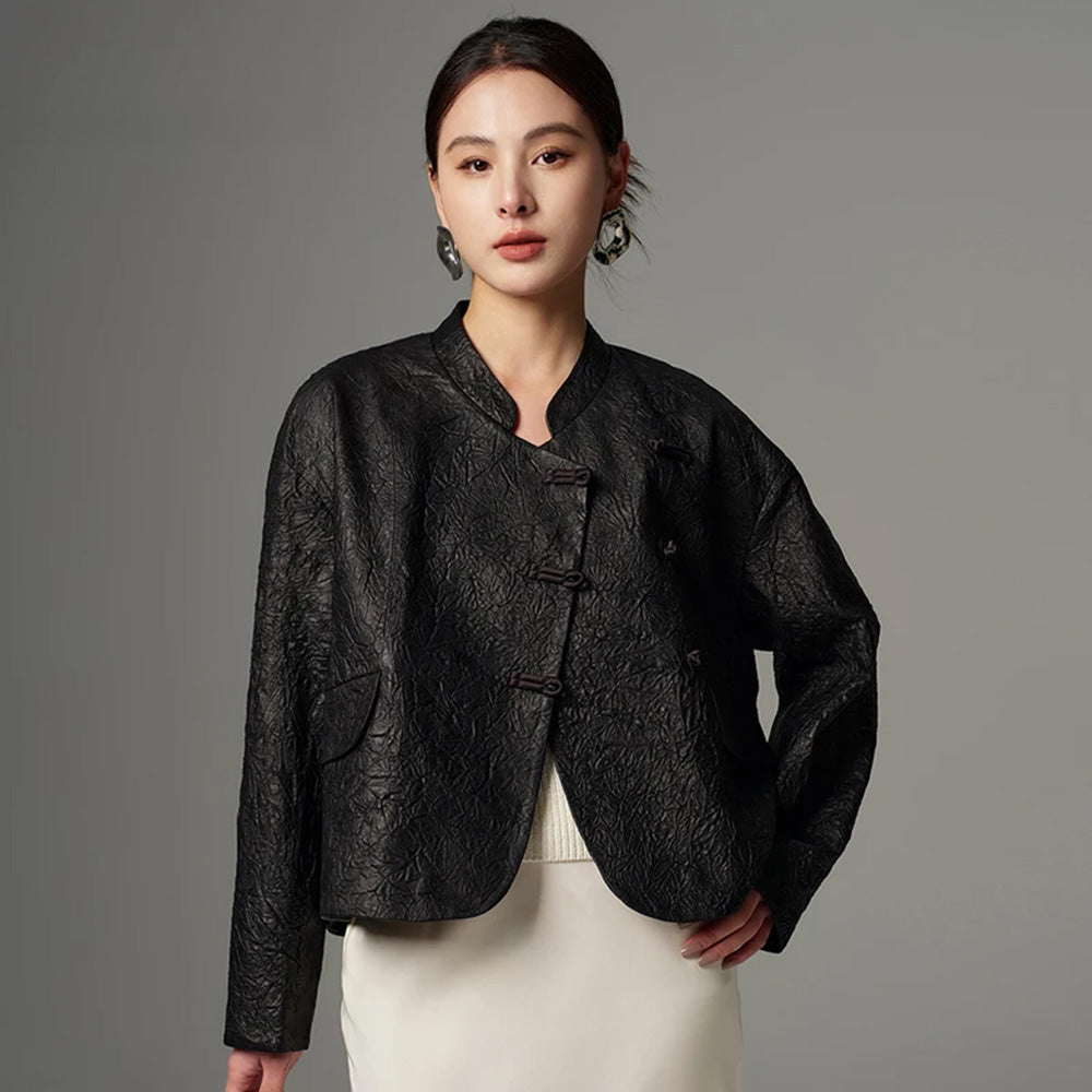 Women's Cropped wrap jacket in full-grain crinkled sheepskin. An austere silhouette with an asymmetrical satin pankou closure, mandarin collar, and high-low hem.  Color - Frost-Glazed Lava. — From Borcelleclothes.