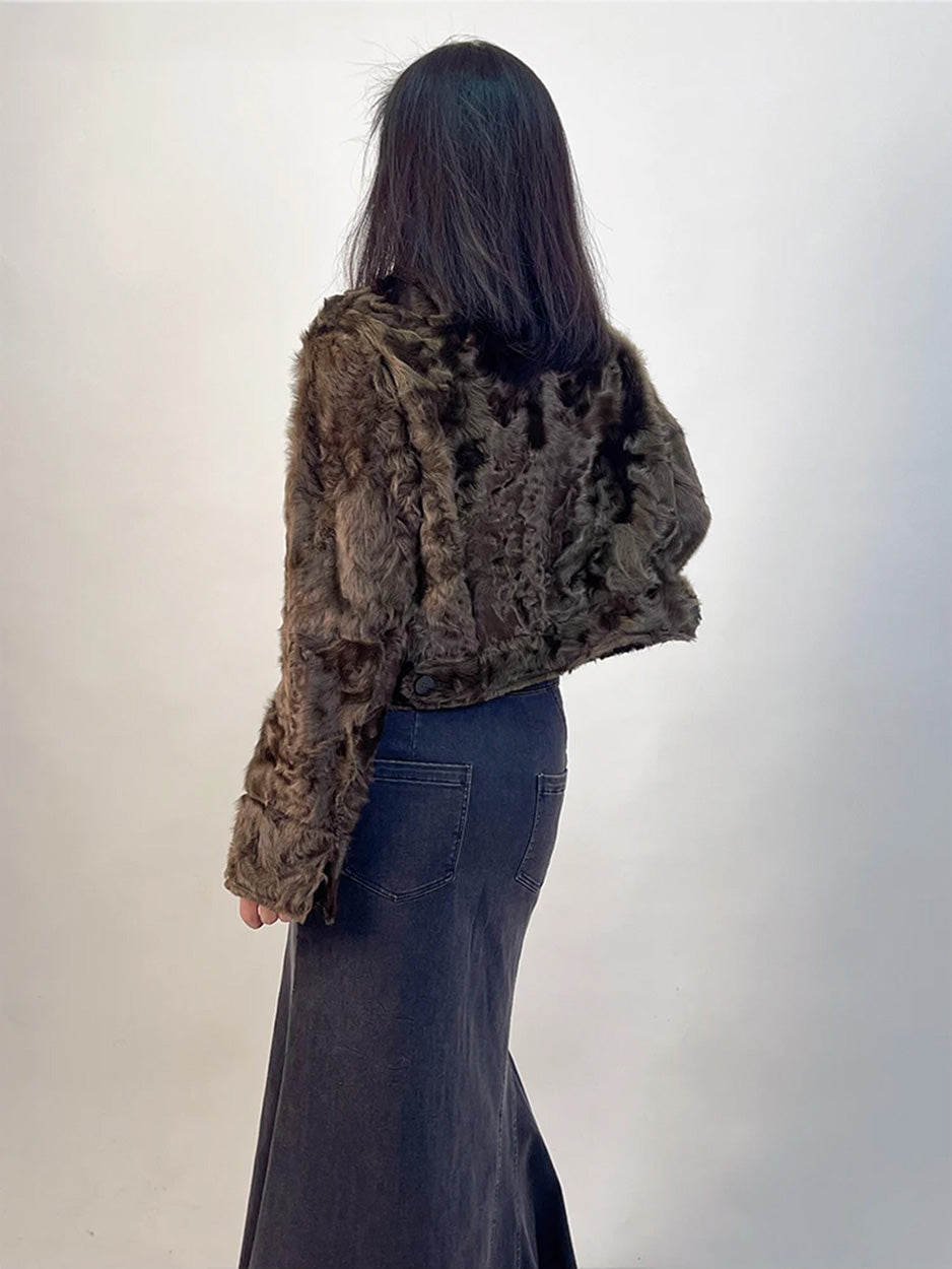 The clean, structural back of the cropped shearling shirt-jacket, emphasizing its impeccable fit and the rich, spice-toned depth of the wool. — From Borcelleclothes.
