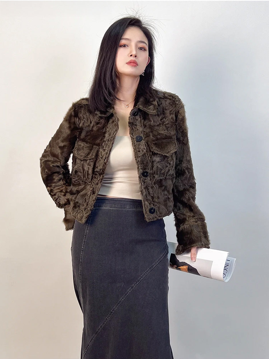 An effortless blend of intellect and style: a woman in the Star Anise jacket holding a journal with a poised, architectural allure. — From Borcelleclothes.