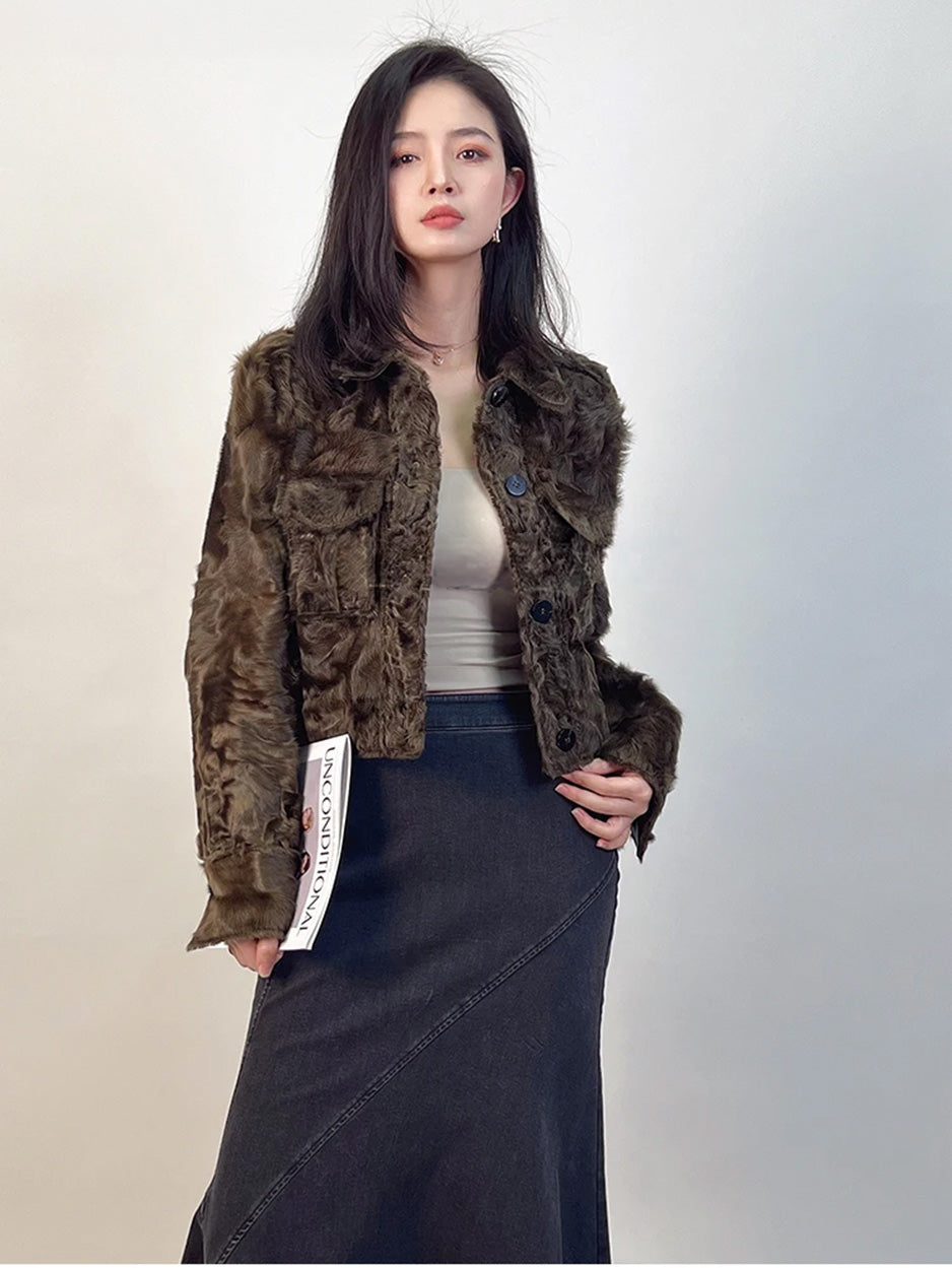 A tactile moment exploring the hem of the Star Anise shearling jacket, showcasing the density and «sting» of the spice-colored fleece. — From Borcelleclothes.