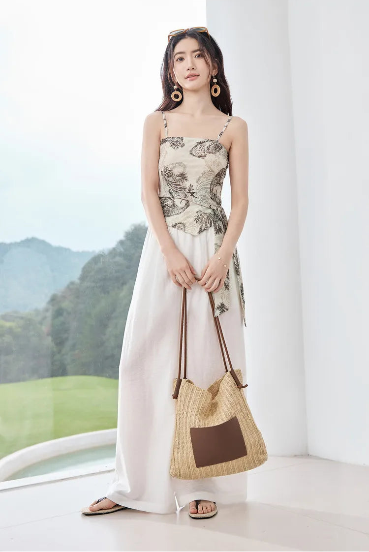 Woman in the Alabaster Mirage three-piece set, styled with a bag to showcase a sophisticated travel look. From Borcelleclothes.