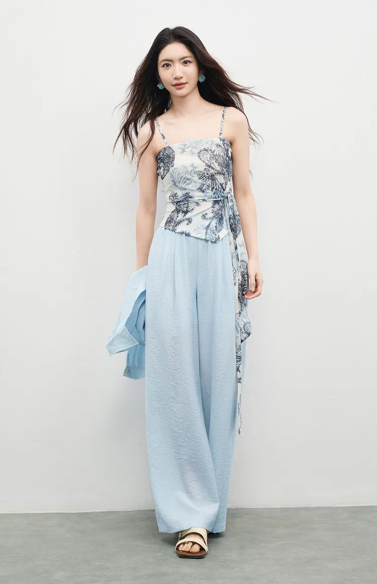 Woman walking in the Lapis Shimmer set, demonstrating the shimmering, water-like movement of the wide-leg trousers. From Borcelleclothes.