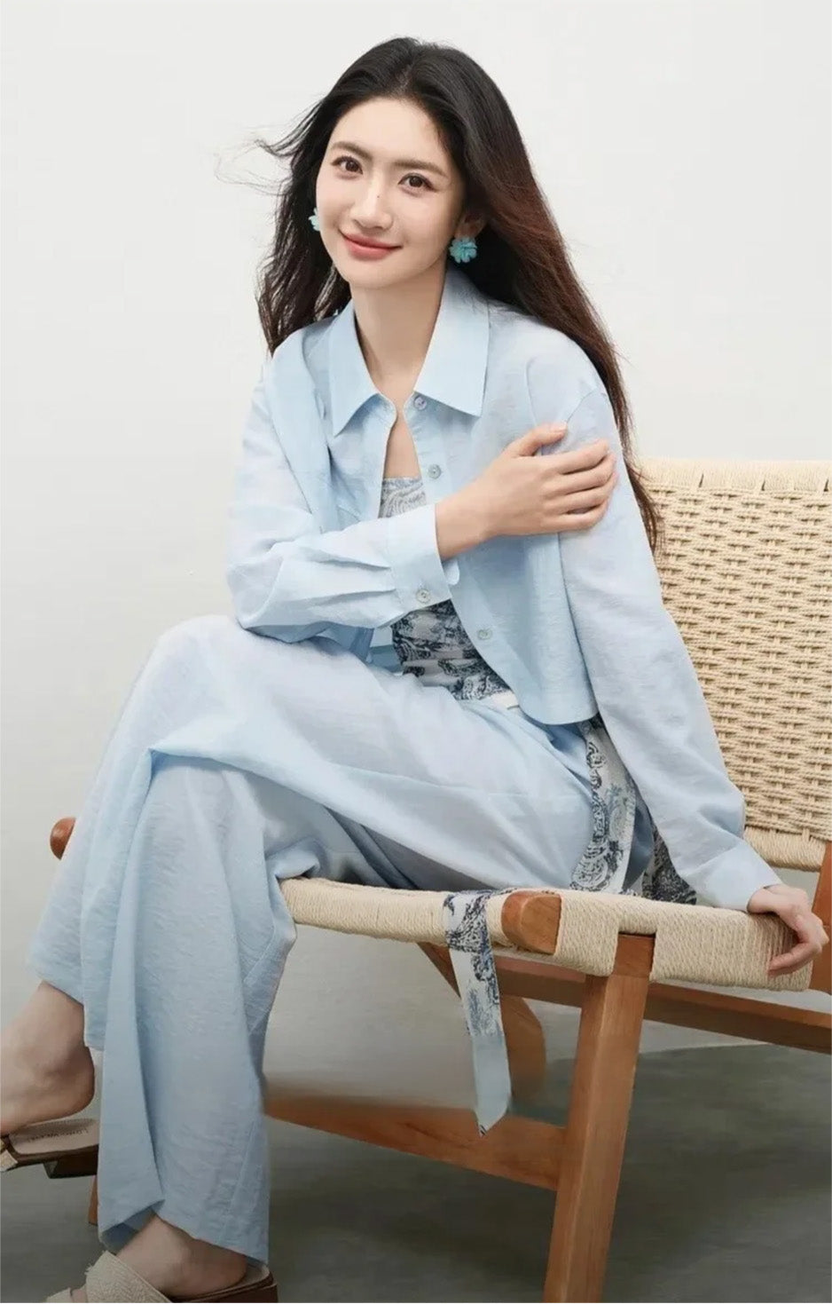 Seated woman in the Lapis Shimmer set, showcasing the relaxed fit and natural drape of the shirt sleeves. From Borcelleclothes.
