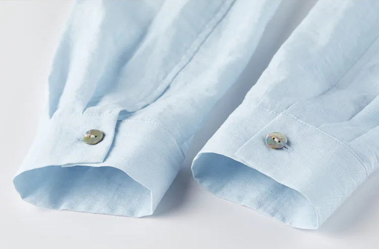 Detailed view of the buttoned cuffs on the Lapis Shimmer cropped shirt. From Borcelleclothes.