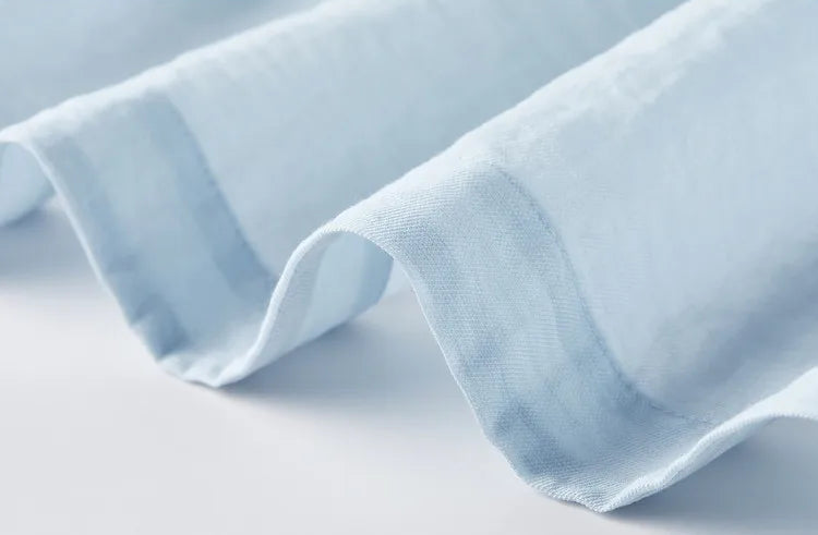 Close-up of the rounded front hem of the Lapis Shimmer shirt, inspired by gypsum plasterwork. From Borcelleclothes.