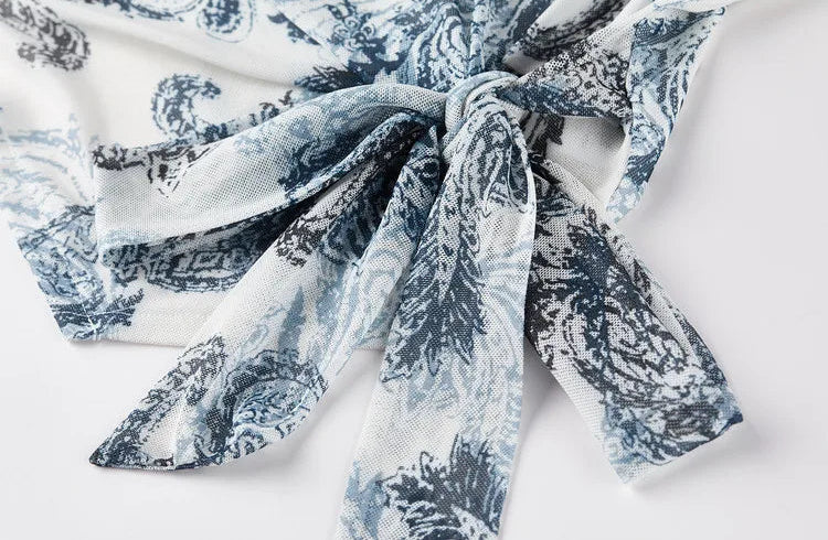 Close-up of the elegant side-tie bow on the Lapis Shimmer draped top. From Borcelleclothes.