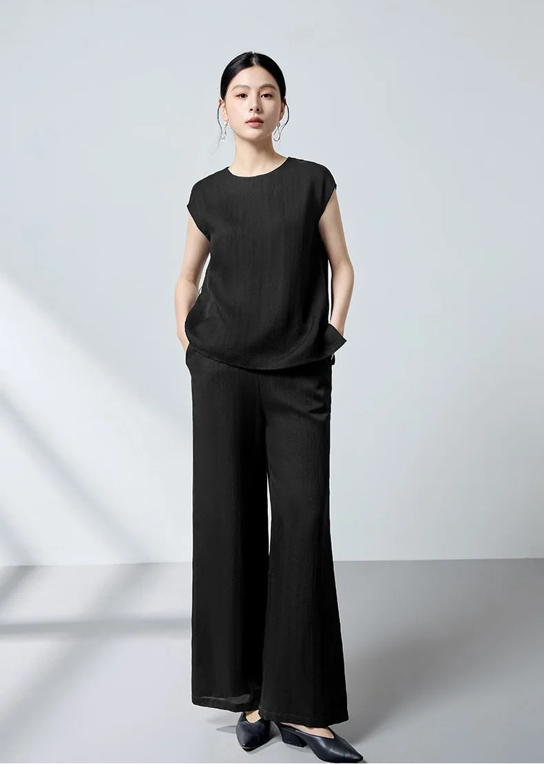 Model wearing the Queen of Spades mulberry silk blouse with hands in pants pockets — From Borcelleclothes.