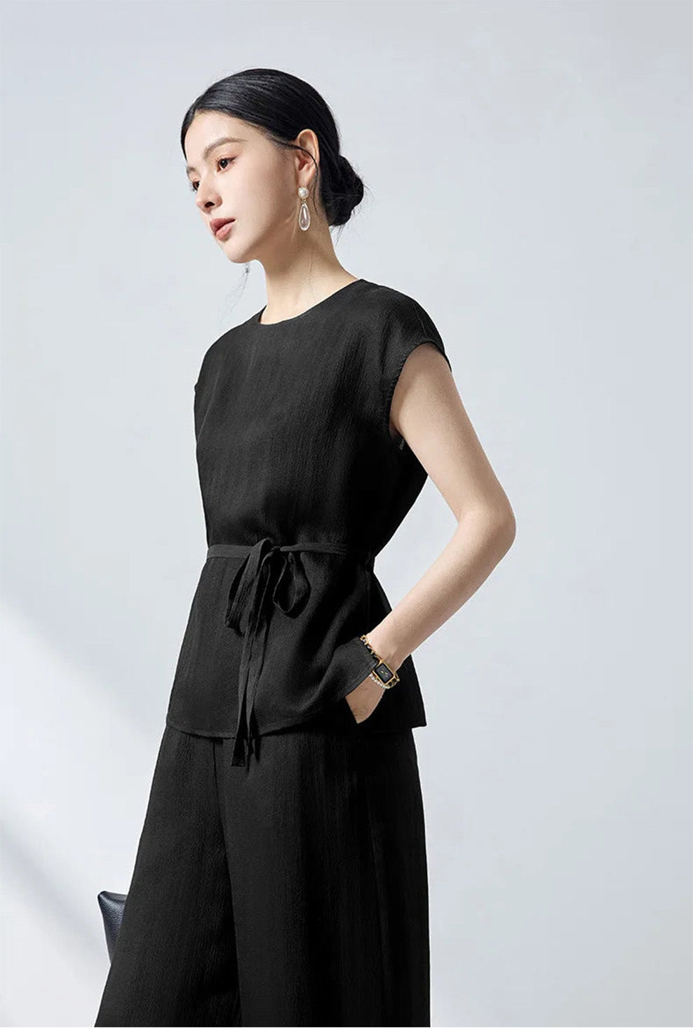Side profile of the women's defined waist mulberry silk blouse in Queen of Spades on model — From Borcelleclothes.