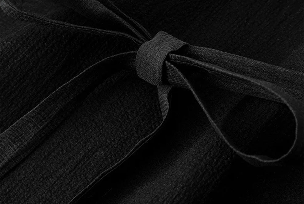 Close-up of the tied waist sash on the Queen of Spades mulberry silk blouse — From Borcelleclothes.