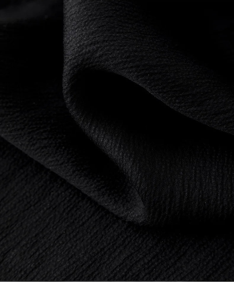Close-up of the 3D wave-folded jacquard texture on the Queen of Spades silk blouse — From Borcelleclothes.