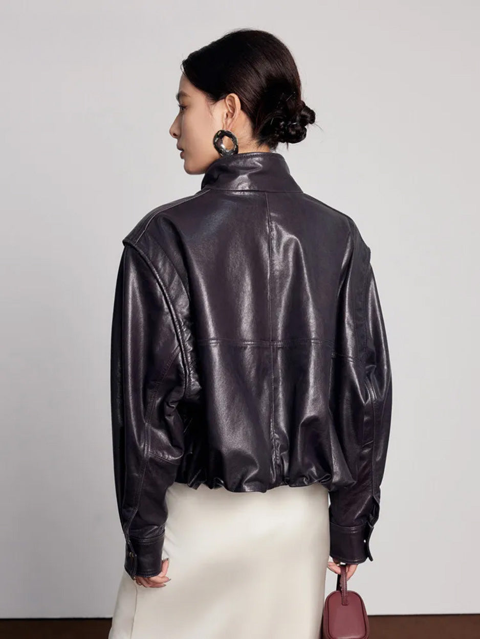 Back view of the sheepskin jacket highlighting the structured silhouette and inward-folded domed hem — From Borcelleclothes.