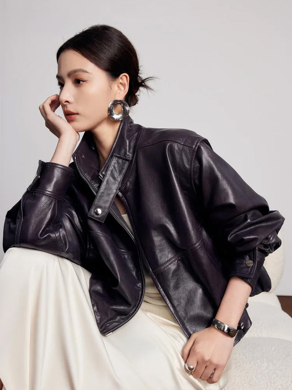 Model seated on a sofa wearing the soft-waxed sheepskin jacket with batwing sleeves — From Borcelleclothes.