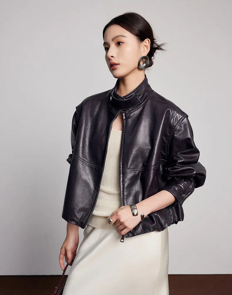 Side-profile view capturing the stand collar, dropped shoulder line, and batwing sleeve drape — From Borcelleclothes.