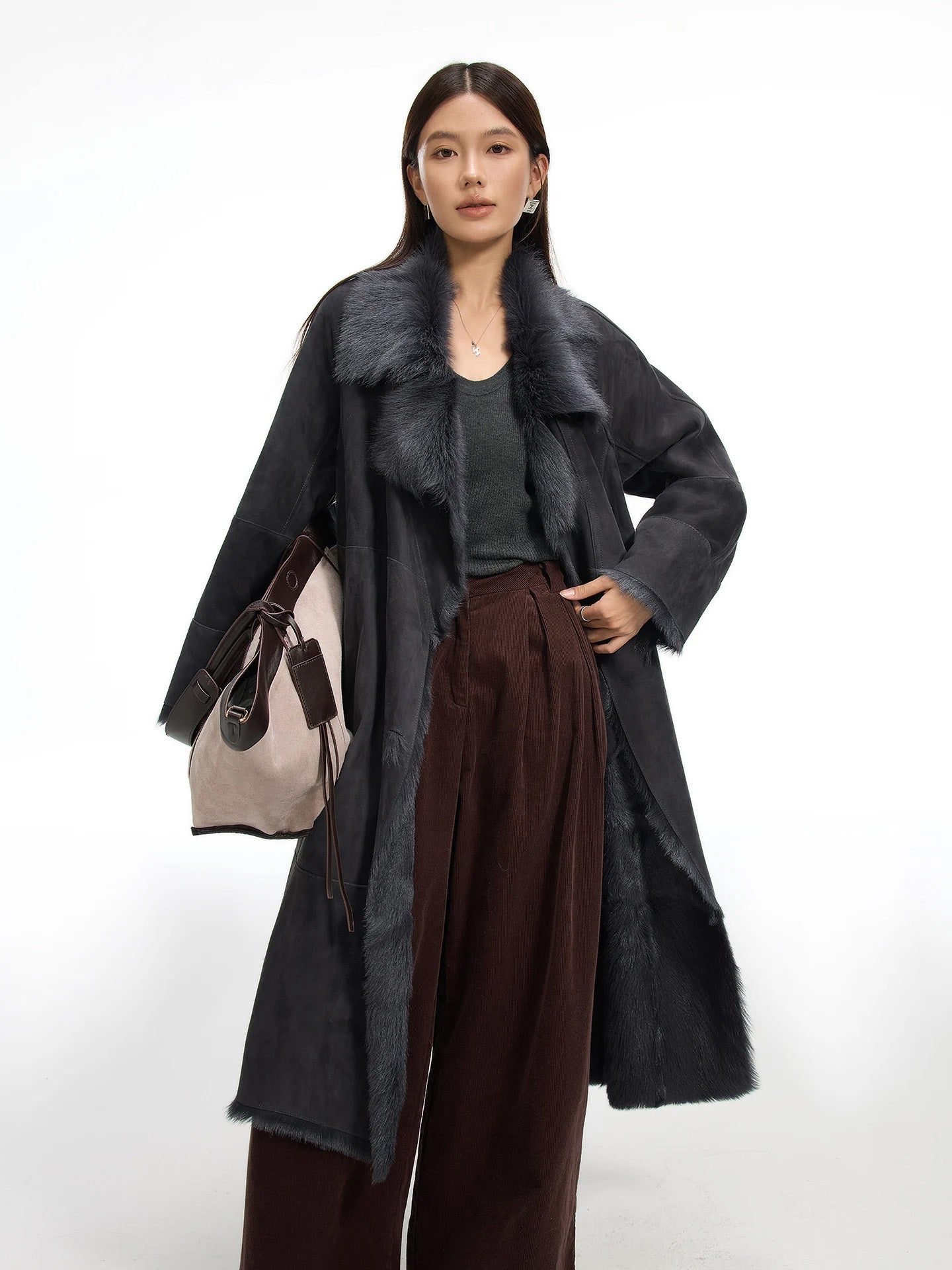 Model wearing the Enigma double-breasted goatskin coat unfastened, with hand resting on hip and soft lapels visible. — From Borcelleclothes.