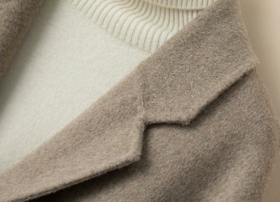 The lapel and shoulder of the Women’s Double-Sided Australian Wool Jacket in Almond Frost, showcasing precise tailoring and luxurious fabric texture. From Borcelleclothes.