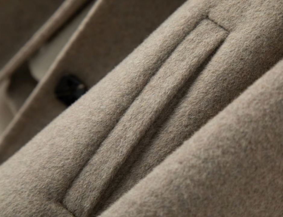 The diagonally exposed single-welt pocket on the Women’s Double-Sided Australian Wool Jacket in Almond Frost, blending practicality with elegance. From Borcelleclothes.