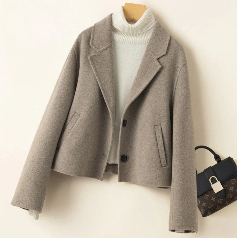 Women’s Double-Sided Australian Wool Jacket in Almond Frost, featuring a tailored silhouette, notch lapels, and a single-breasted design with two buttons. Crafted from 100% Australian wool, this jacket combines timeless elegance with sustainable luxury. From Borcelleclothes.