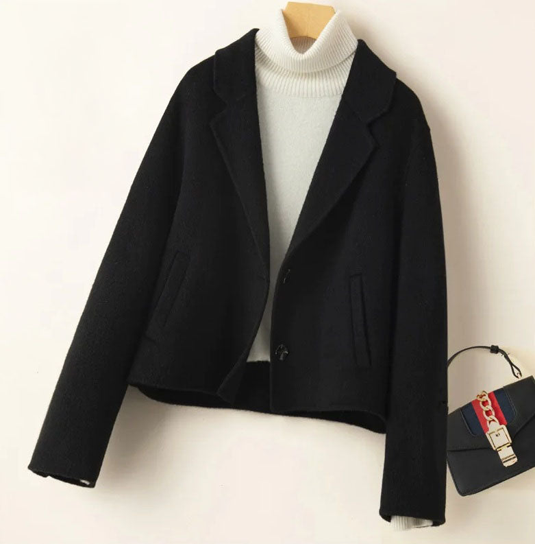 Women’s Double-Sided Australian Wool Jacket in Onyx, featuring a tailored silhouette, notch lapels, and a single-breasted design with two buttons. Crafted from 100% Australian wool, this jacket combines timeless elegance with sustainable luxury. From Borcelleclothes.