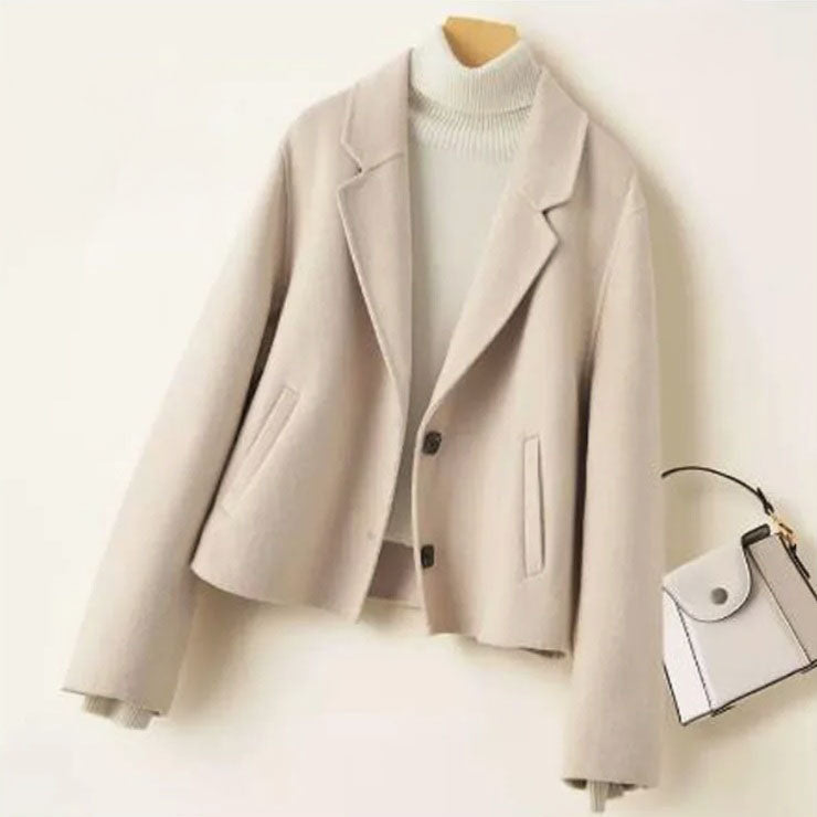 Women’s Double-Sided Australian Wool Jacket in Pearl Lusta, featuring a tailored silhouette, notch lapels, and a single-breasted design with two buttons. Crafted from 100% Australian wool, this jacket combines timeless elegance with sustainable luxury. From Borcelleclothes.