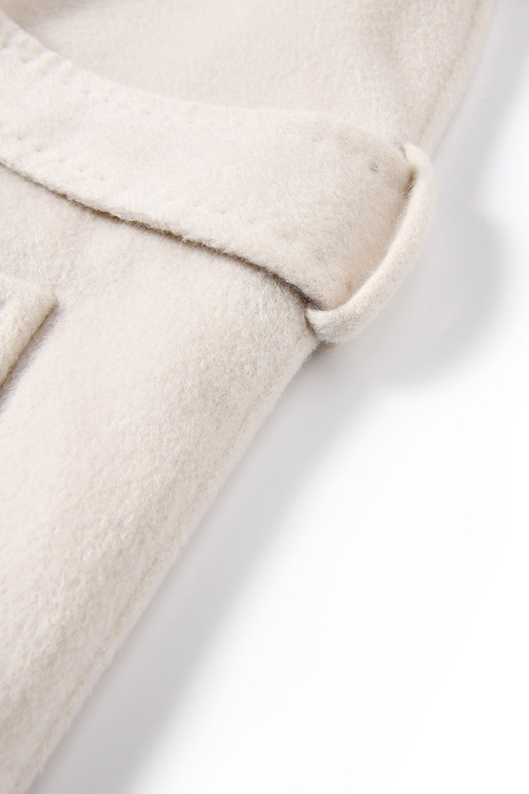 Detail of the defined waist and side belt loop on the Moment of Promise coat — From Borcelleclothes.
