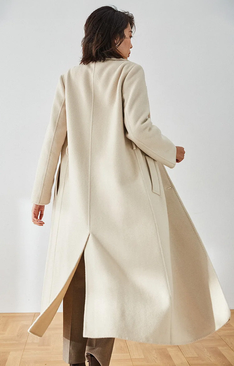 Rear view of the Moment of Promise coat, showcasing the mid-calf length and back vent — From Borcelleclothes.