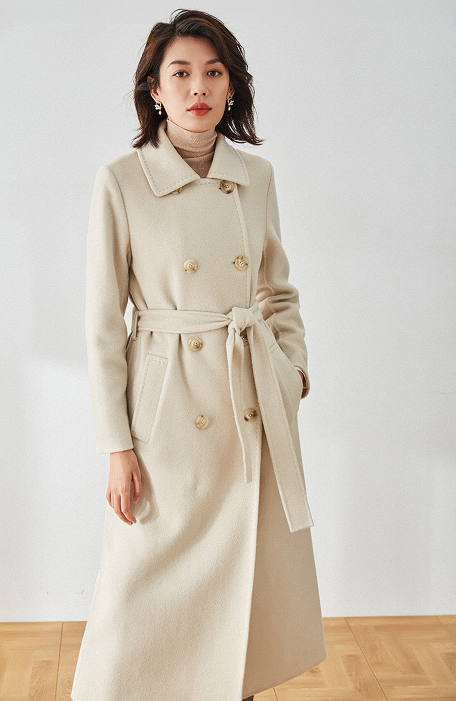 Moment of Promise beige coat, model with one hand in the welt pocket — From Borcelleclothes.