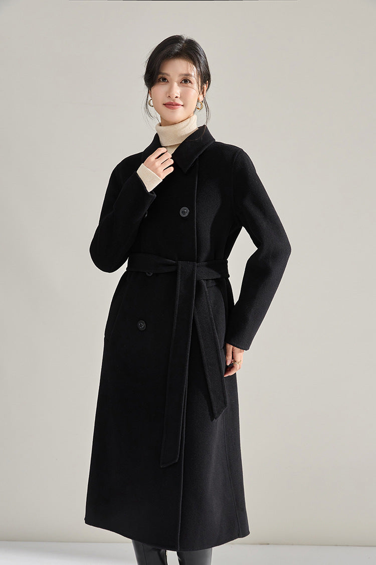 Model touching the collar on the Shadow of a Word black coat — From Borcelleclothes.