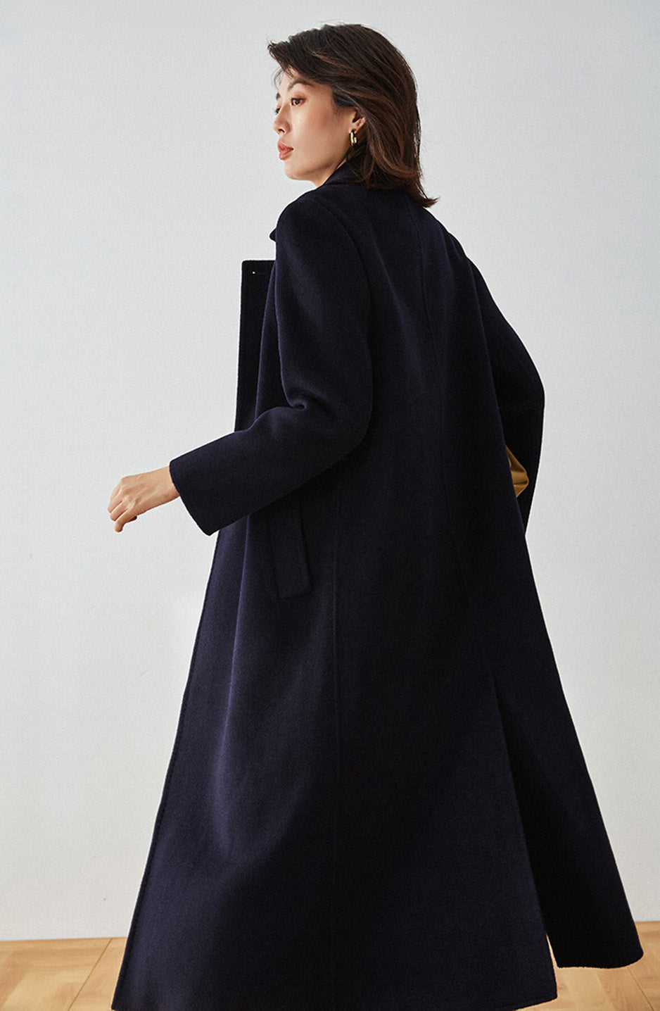 Side view of the unfastened Written in Ink coat in navy blue — From Borcelleclothes.