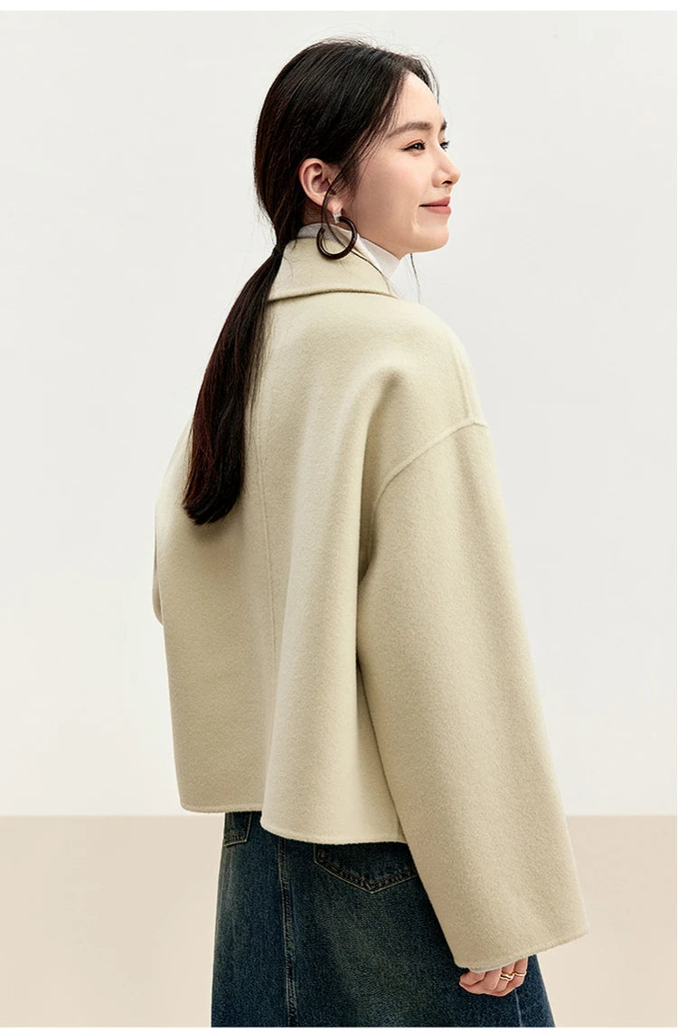 A side view of a woman in the Edelweiss Pollen jacket, highlighting the dropped shoulder and pointed collar — From Borcelleclothes.