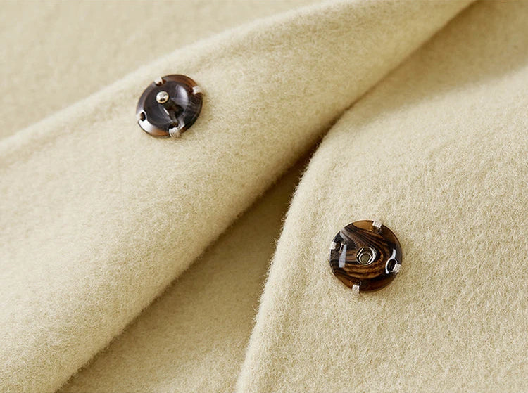 A close-up of the Edelweiss Pollen jacket with an unfastened snap, revealing the clean double-sided finish — From Borcelleclothes.