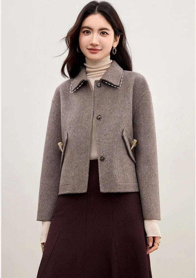 A woman standing straight in the Lost Summit double-sided wool jacket, emphasizing the clean, unlined construction — From Borcelleclothes.