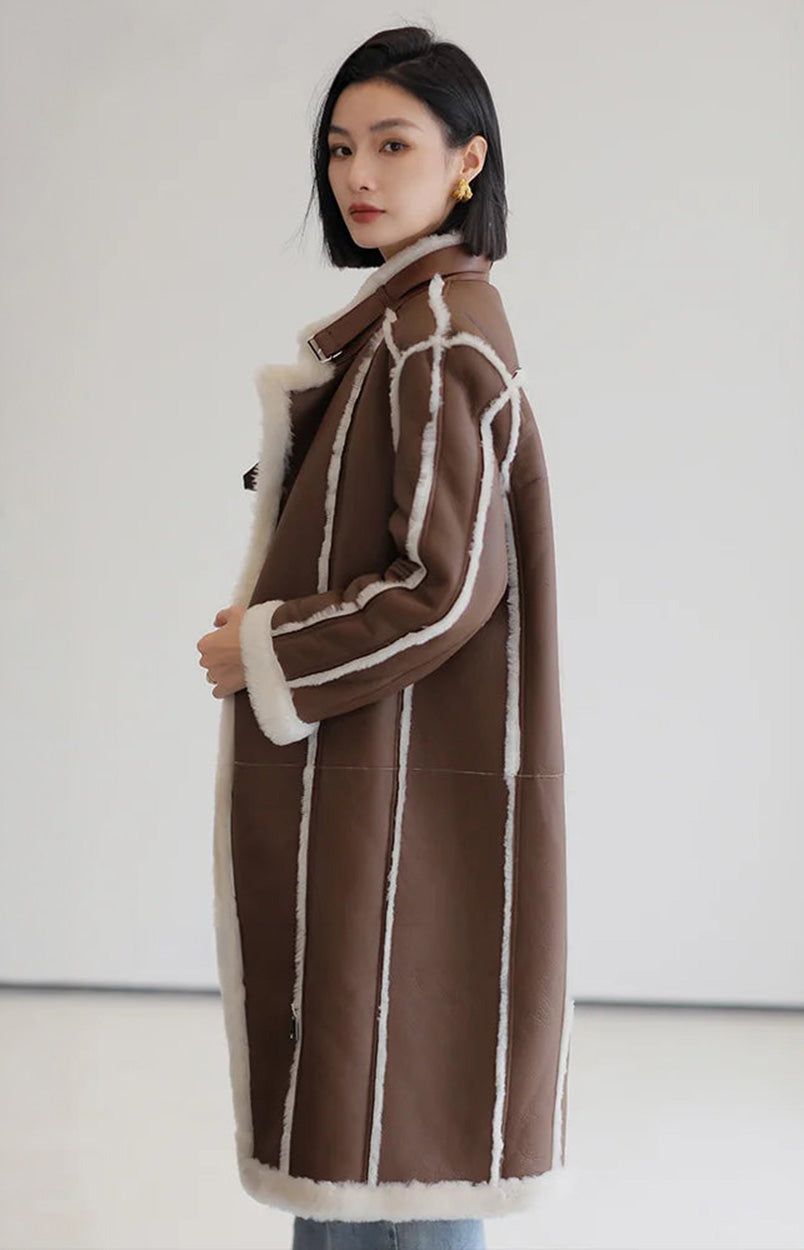 Side view of the Drambuie Cocktail shearling coat, showing long silhouette and curved panels — From Borcelleclothes.