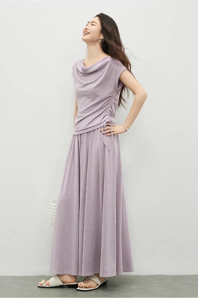 Side view of the silhouette, showing the fluid transition between the top and the midi skirt. — From Borcelleclothes.