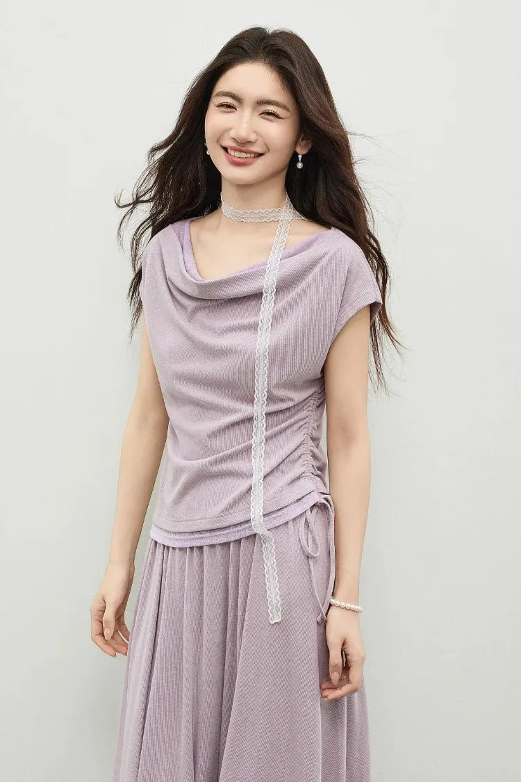 Close-up of a smiling model, emphasizing the effortless drape of the sleeveless rib-knit top. — From Borcelleclothes.