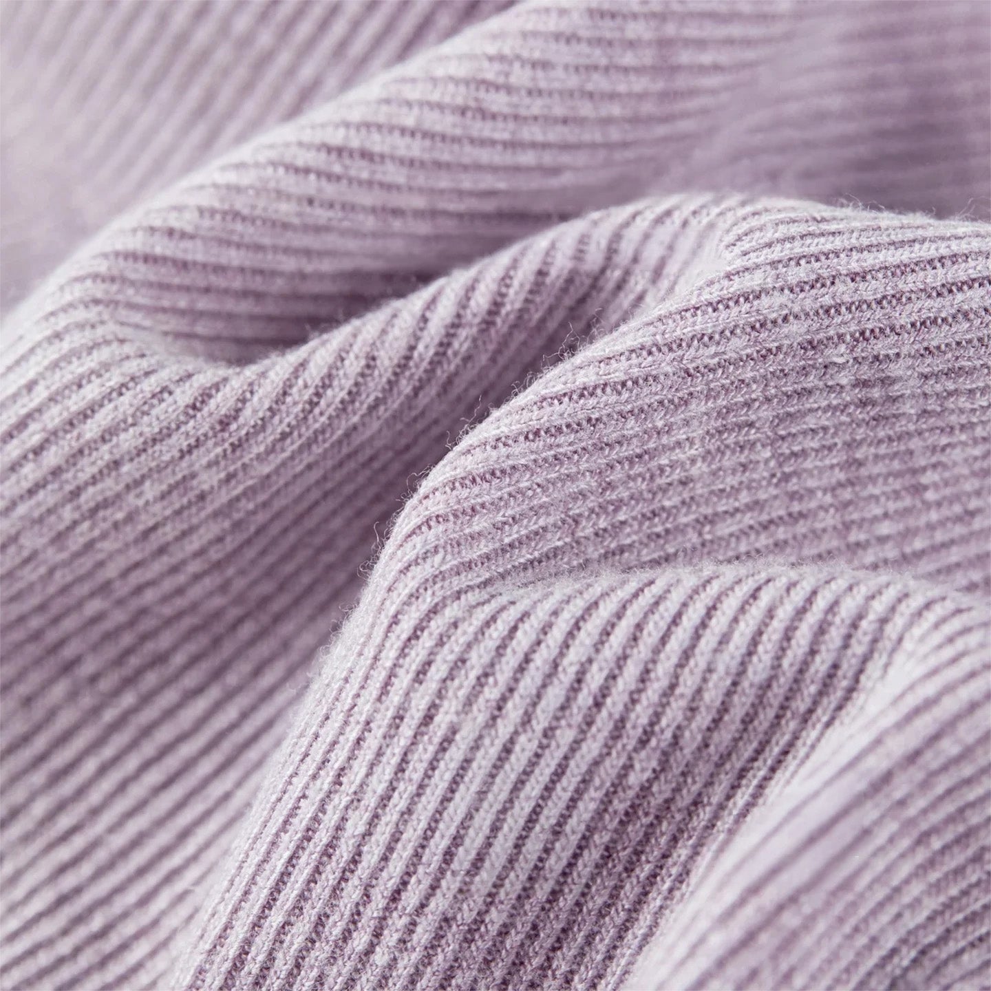 The poetic rhythm of 1x1 rib-knit: close-up of the wave-folded viscose texture. — From Borcelleclothes.