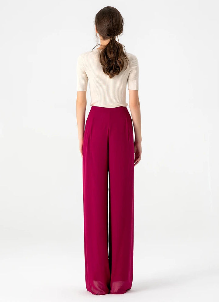 Full-length back view of Mulberry silk georgette wide-leg trousers in Raspberry Perspective showing fluid volume — From Borcelleclothes.