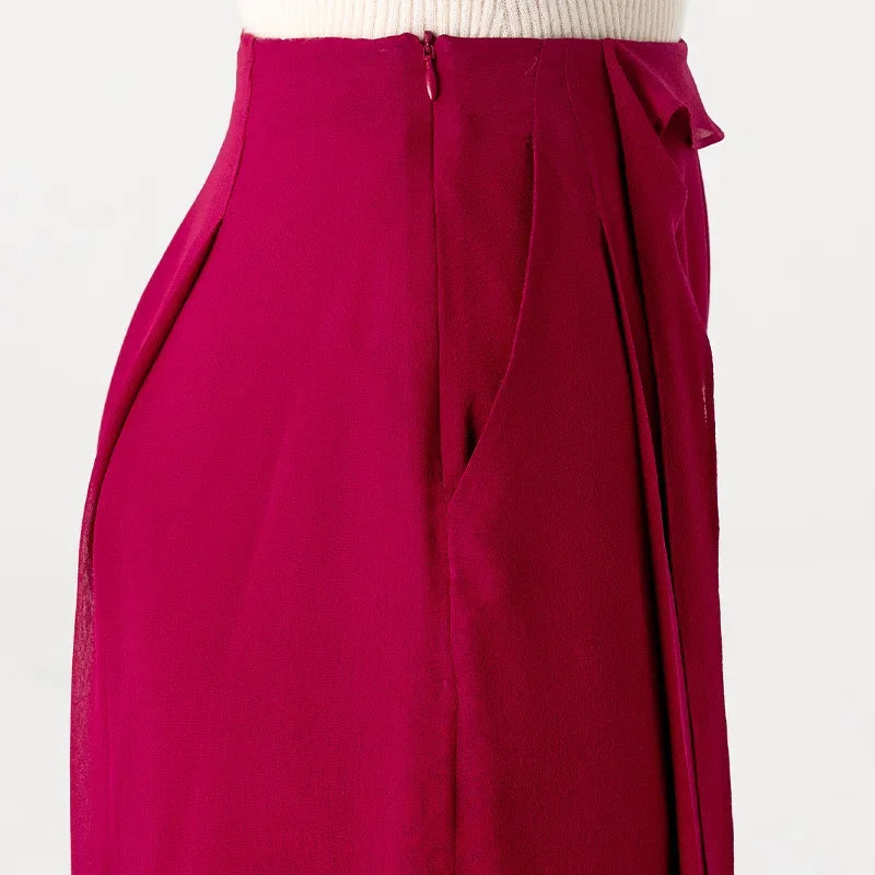 Close-up side waist view of silk georgette trousers in Raspberry Perspective showing hidden side zipper and pleat construction — From Borcelleclothes.