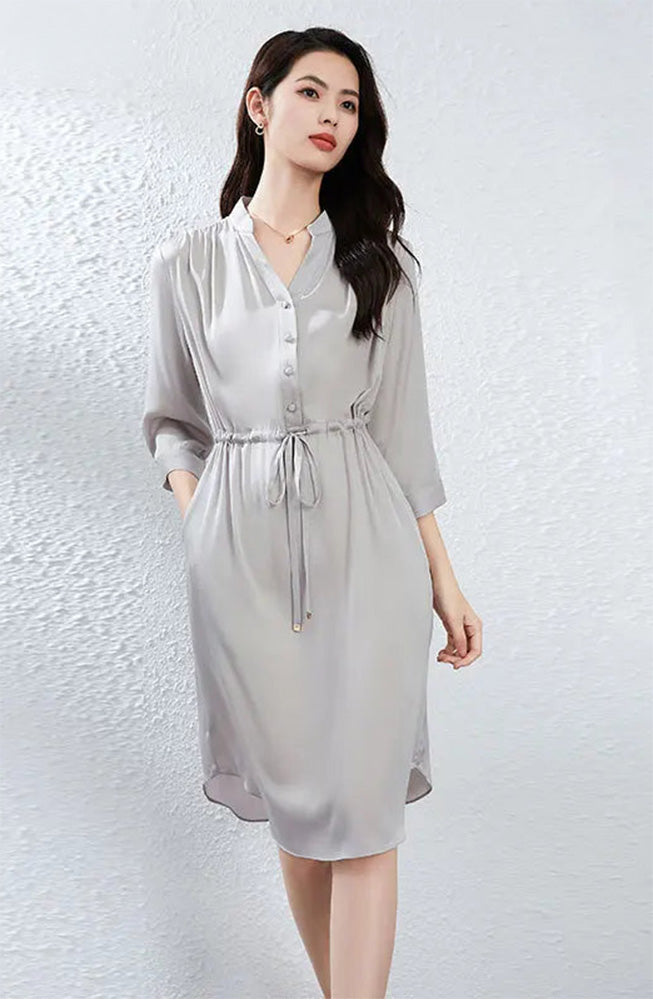 A woman wearing the Behind the Clouds silk dress with one hand in her pocket, emphasizing the effortless elegance of the design. — From Borcelleclothes.