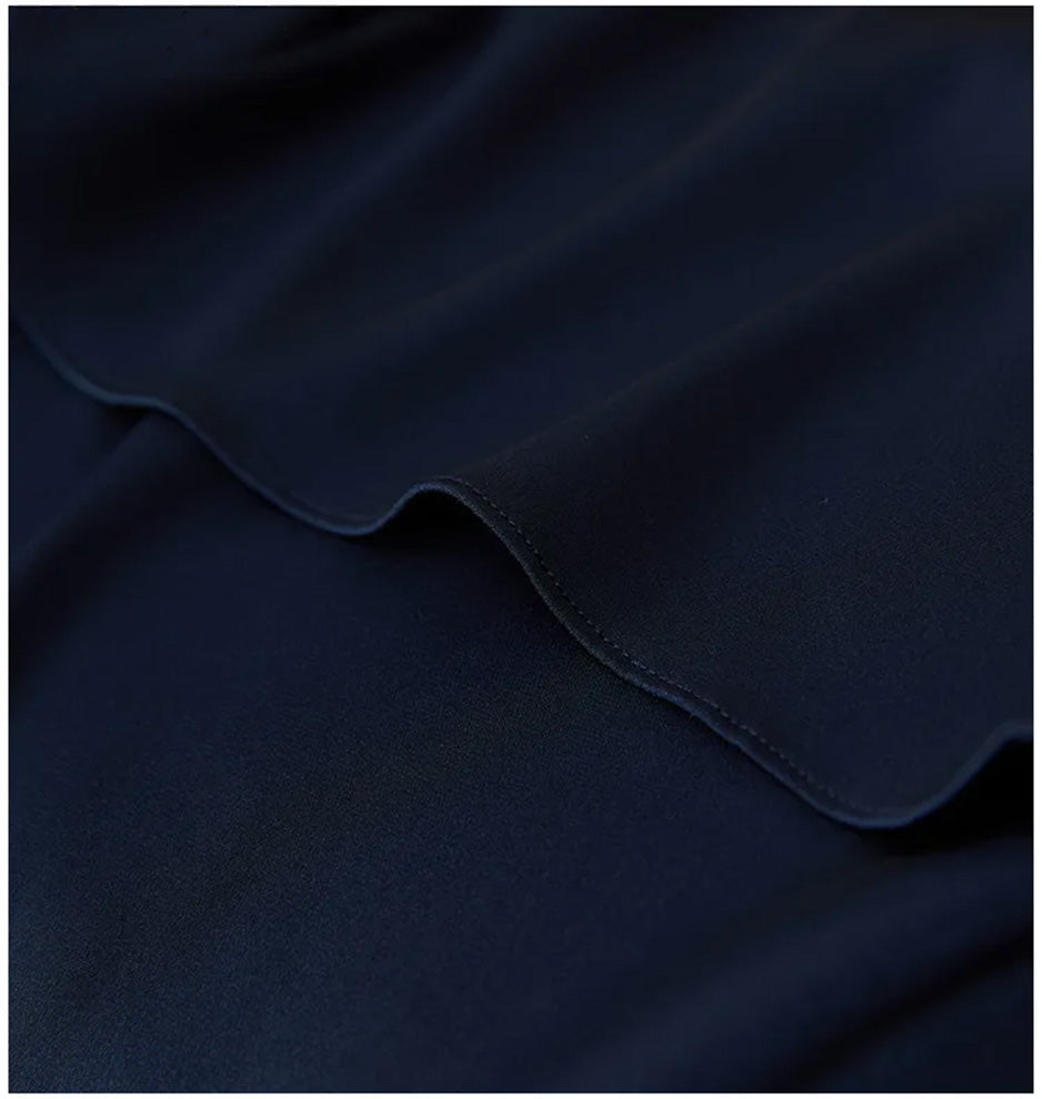 View of the curved high-low hem, showing the rounded side slits and the graceful movement of the silk. — From Borcelleclothes.