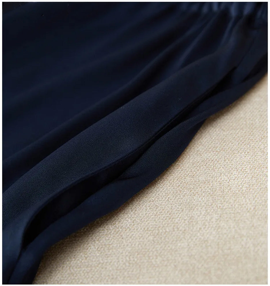 Detailed shot of the side seam pocket entry, seamlessly integrated into the fluid silk fabric. — From Borcelleclothes.
